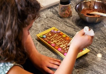 School student decorating chocolate Maison Cailler